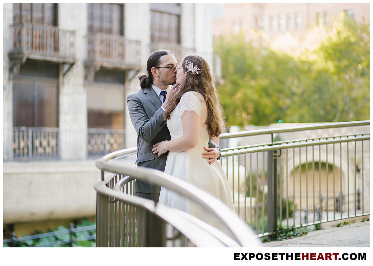 Bride and Groom kissing by the San Antonio River Walk after getting married downtown