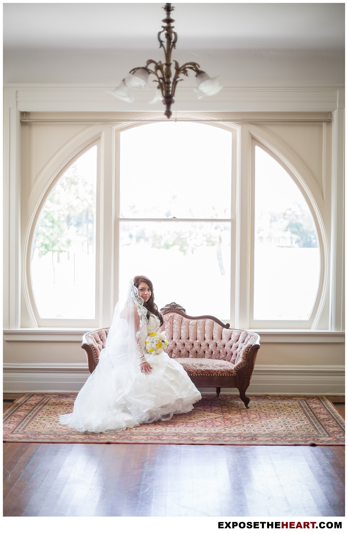 Bride sitting on couch at The Lambermont Mansion wedding venue in San Antonio fir her bridal