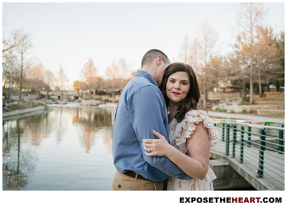 San Antonio engagement photographer captures couple embracing by the Riverwalk at the Pearl Brewery.